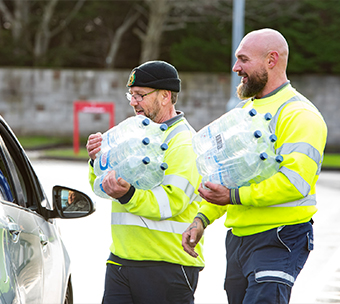 helping with bottles of water